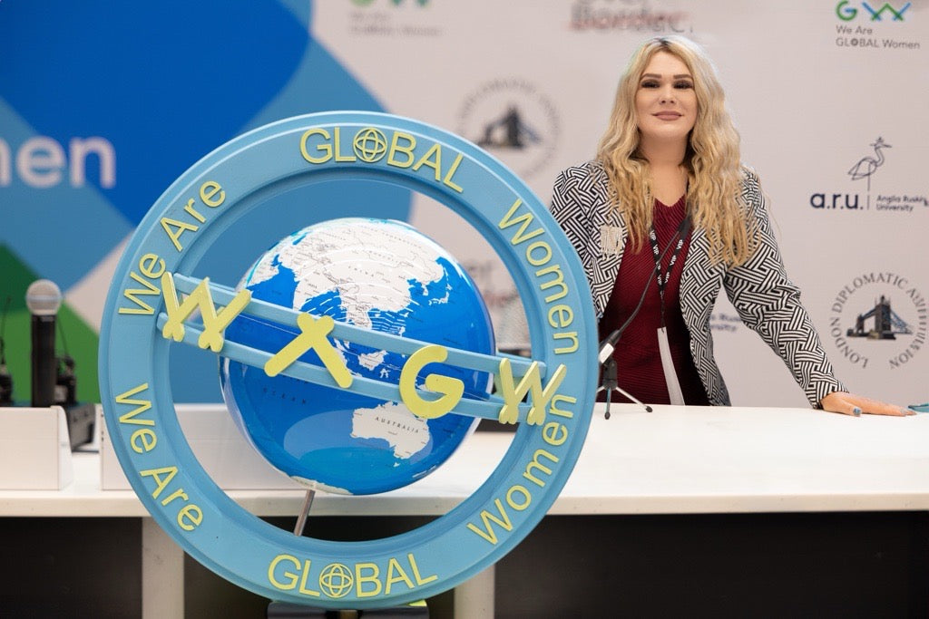 Woman standing behind desk with WAGW branding